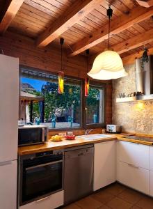 a kitchen with a sink and a stove top oven at Casa rural con piscina cubierta en Segovia - Viento de Ladera in Segovia