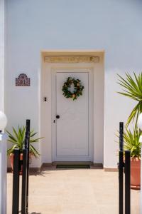 a white door with a wreath on it at Lemon Tree Villa in Paralimni