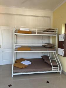 a room with two bunk beds in a room at The Cave house hostel in Cochin