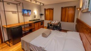 a bedroom with a large white bed in a room at Ap Passarela in Porto Seguro