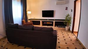 a living room with a couch and a flat screen tv at Ruralux Valentín in Calasparra +78 photos