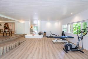 a large room with a gym with a treadmill and a table at Brenaissance Wine & Stud Estate in Stellenbosch