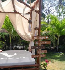 a bed with a bunch of signs next to a tent at Casa di Palmas in Pecém +69 photos