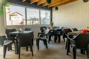 a group of tables and chairs in a restaurant at R & A Resident in Năvodari