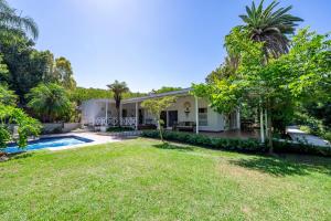 an exterior view of a house with a yard at Brenaissance Wine & Stud Estate in Stellenbosch
