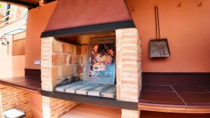 a brick fireplace with a picture of a woman at Ruralux Valentín in Calasparra