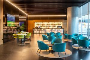 a restaurant with blue and green chairs and tables at Alexandre Fira Congress in Hospitalet de Llobregat
