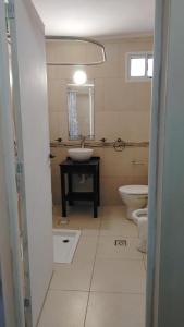 a bathroom with two toilets and a sink and a mirror at Magda in Resistencia