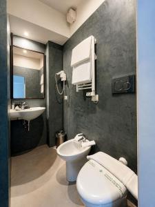 a bathroom with a toilet and a sink at BB Hotels Smarthotel Missori in Milan +43 photos