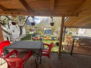 a table and chairs on a patio with a playground at Guest House GURI in Vusanje