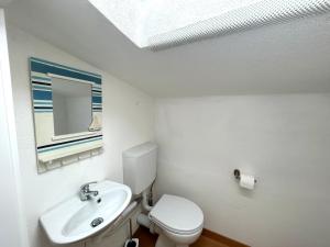 a bathroom with a white toilet and a sink at Sardinia Breeze - Costa Serena in Porto Rafael
