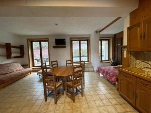 a kitchen and living room with a table and chairs at Chalet Le Refuge in Samoëns