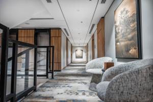 a hallway with two chairs and a table in a building at Ayas Hail Hotel - فندق أياس حائل in Hail +65 photos