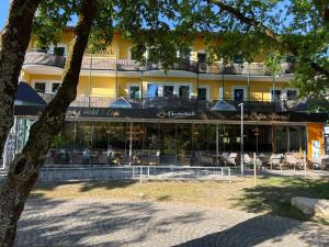 a hotel with tables and chairs in front of a building at Hotel Promenade in Bad Füssing