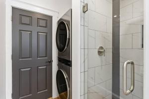 a bathroom with a washer and dryer next to a door at Historic home on Salem Neck in Salem +40 photos