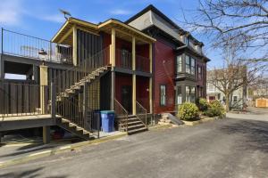a red house with a balcony on a street at Historic home on Salem Neck in Salem