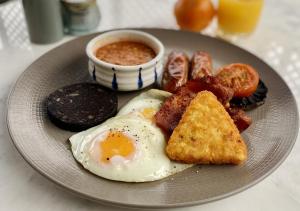 a plate of breakfast food with eggs bacon and toast at The Bubble at Stenson in Stanton