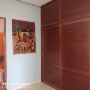 a wooden door in a room with a painting at Ca Azul in Tarrafal