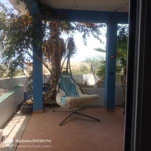 a chair on the porch of a house at Ca Azul in Tarrafal