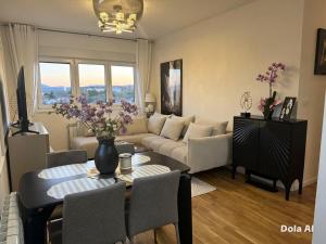 a living room with a couch and a table at Stan na dan Bor Apartman in Bor