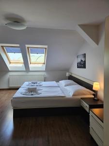 a bedroom with a large bed and two windows at Residence Vysta in Prague