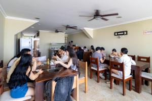 a group of people sitting at tables in a restaurant at Hotel Marvento Suites in Salinas