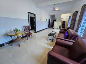 a living room with a couch and a table at Anou Home - Guesthouse in Siem Reap +25 photos