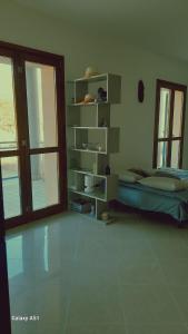 a bedroom with a bed and a book shelf at Le Persiane Azzurre est in Albiano