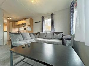 a living room with a couch and a coffee table at Brechin Getaway the rowan 2 bedroom static in Angus