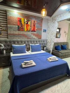 a bedroom with a blue bed with towels on it at Hotel City Building2 in Zugdidi +40 photos