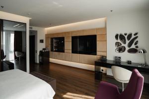 a bedroom with a bed and a desk and chairs at 11 Mirrors Design Hotel in Kyiv
