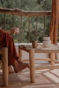 a person sitting on a porch with their feet on a table at Can Vistabella Boutique Resort in San Antonio