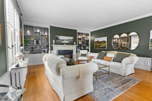 a living room with two chairs and a fireplace at Historic Salyards Mansion by Heirloom Boutique Collection in Duluth
