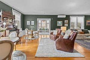 a living room with green walls and furniture at Historic Salyards Mansion by Heirloom Boutique Collection in Duluth +13 photos