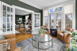 a living room filled with furniture and a fireplace at Historic Salyards Mansion by Heirloom Boutique Collection in Duluth