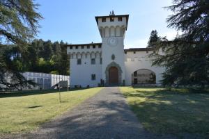 a building with a clock tower on top of it at Martini River House in Barberino di Mugello
