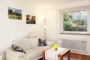 a living room with a couch and a window at Ferienwohnung Kastanienblick in Uelzen