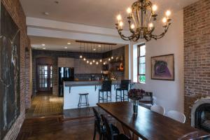 a dining room with a table and a bar at Casa Hudson in Haverstraw