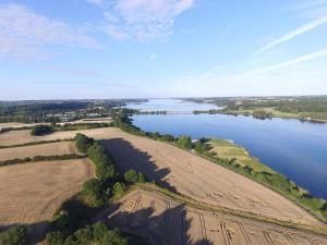 an aerial view of a field and a river at Ferienwohnung BEA 3 in Rabenkirchen-Faulück +2 photos
