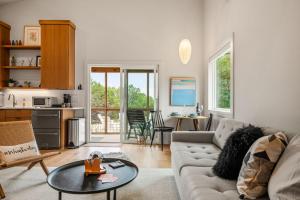 a living room with a couch and a table at Camp Jackalope - Outdoor Trails - Fire Pit - Views in Wimberley +22 photos