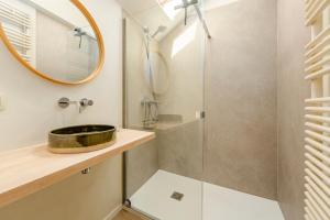 a bathroom with a sink and a shower at Huyze Aïda in Bruges