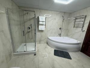 a bathroom with a shower and a toilet and a sink at Cмак бажання in Sebino