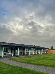 a building with a rainbow in the sky at Lazurowy Zakątek in Dąbki