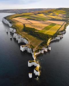 an island with white rocks in the water at Knoll House in Studland