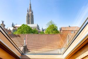 a view from the roof of a building with a clock tower at Huyze Aïda in Bruges