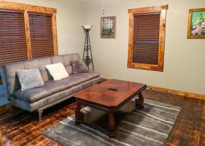 a living room with a couch and a coffee table at The Miner's Getaway in Lead SD in Lead