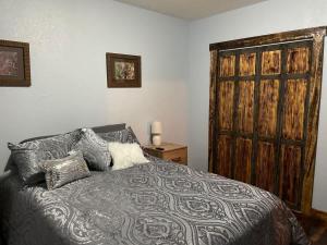 a bedroom with a bed and a wooden door at The Miner's Getaway in Lead SD in Lead