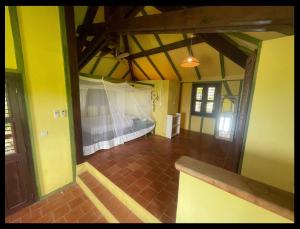 a room with a bed in the middle of a room at Les Nids Tropicaux in Marigot