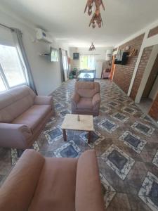 a living room with two couches and a coffee table at El Rincón de mis Abuelos in Albardón