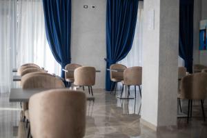 a waiting room with chairs and blue curtains at Hotel Villa Irene & Spa in Rimini
